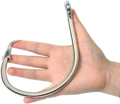 Giant 28/0 stainless steel shark circle hook shown in hand for size comparison, designed for big game saltwater fishing
