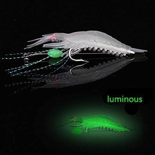 White luminous shrimp fishing lure glowing green in the dark