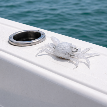 Backwater Crab Oyster White soft plastic lure on boat gunwale with water background inshore fishing bait for sheepshead