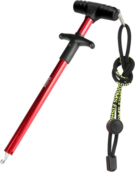 Red anodized aluminum saltwater fishing hook remover with ergonomic handle and wrist lanyard for safe catch and release.